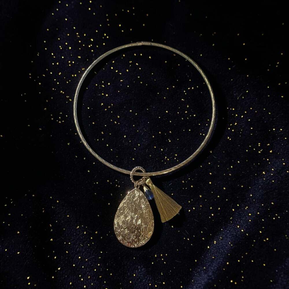 Gold-Tone Omega Choker Necklace with Textured Teardrop Pendant, Blue Crystal, an
